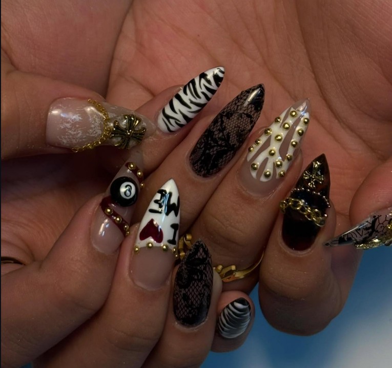 Zebra, lace and gold stud nail art with an 8-ball accent